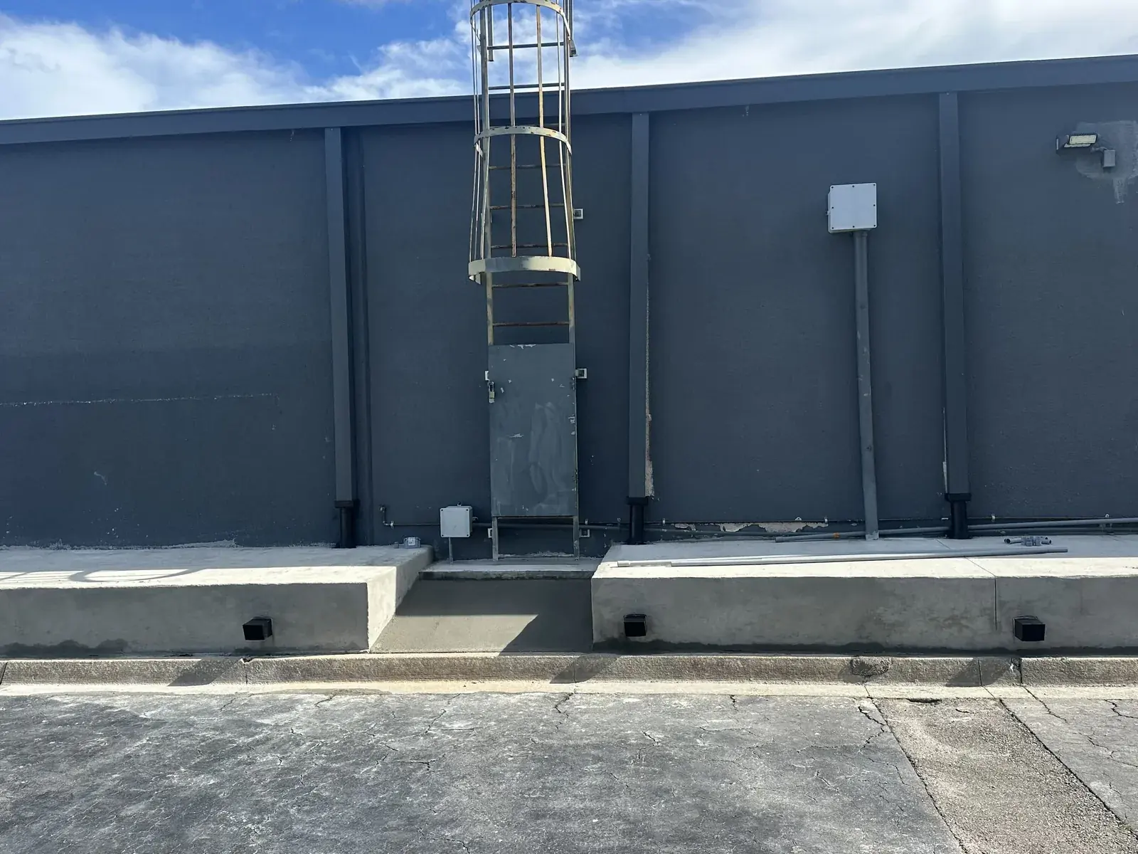 Raised concrete platforms along the back wall of a commercial building