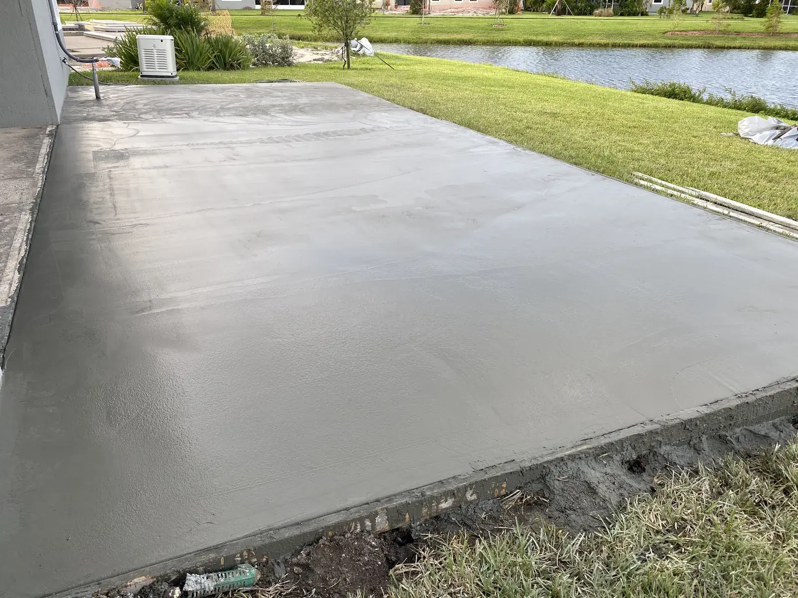 Fresh concrete slab poured behind a lakefront home