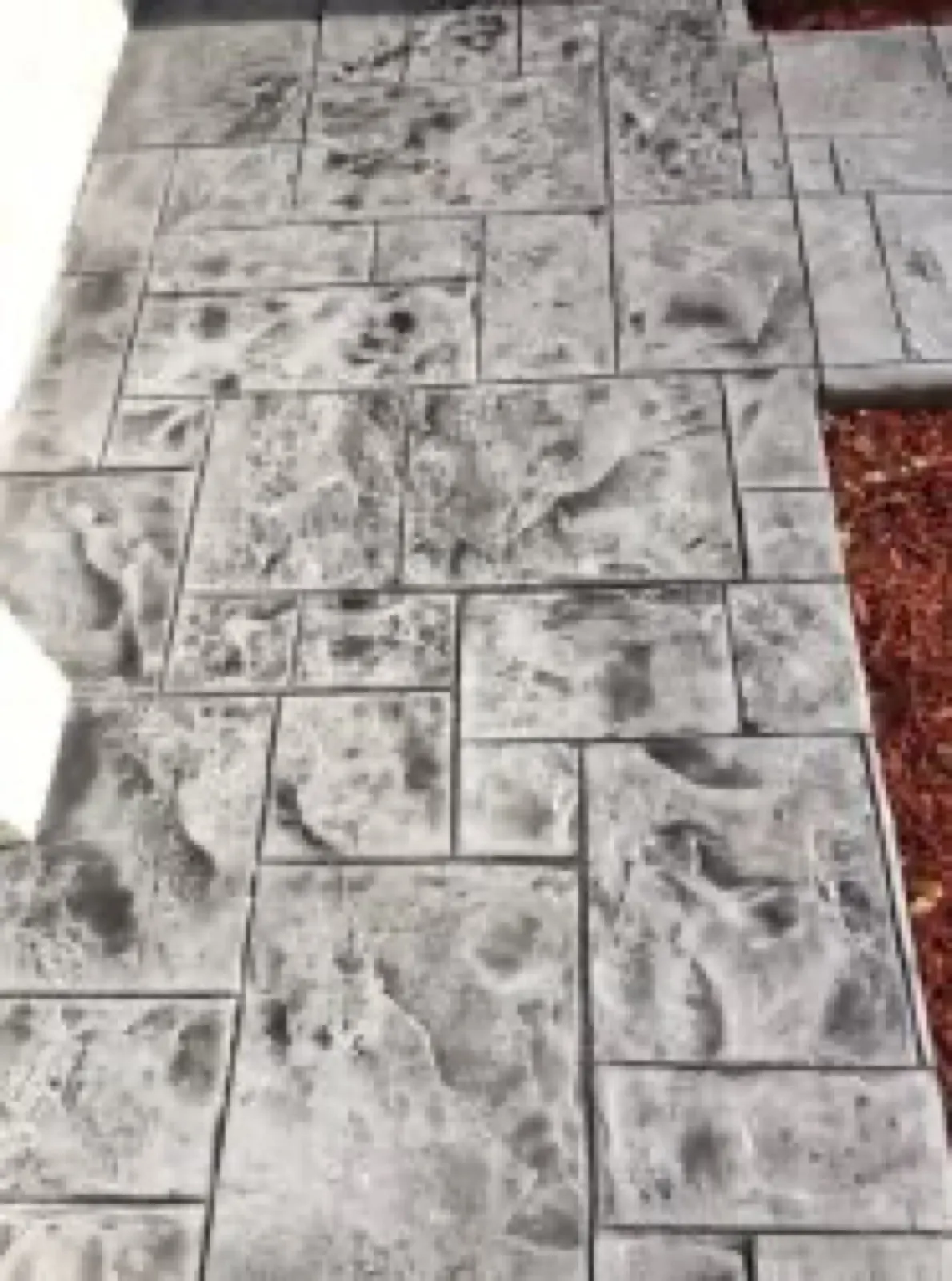 Close up of an ashlar slate pattern stamped into a concrete walk