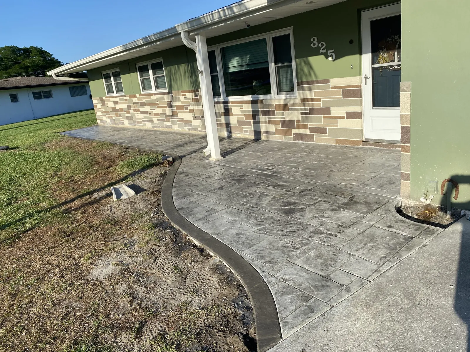 Stamped concrete front entry and walk with a dark border